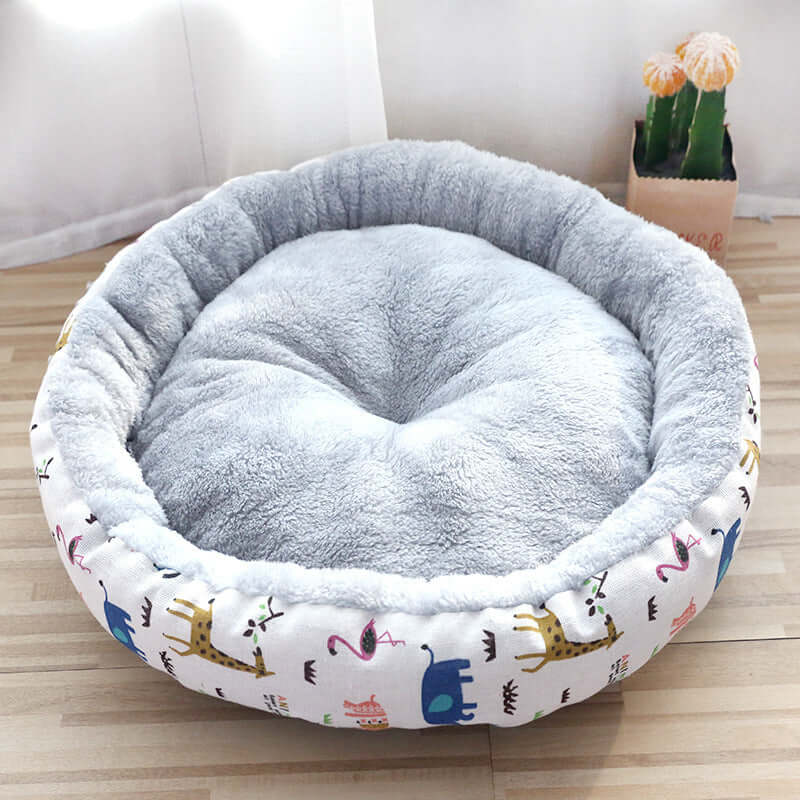 Padded pet litter bed made of Arctic fleece and linen canvas, featuring soft cushioning and colorful cartoon patterns.