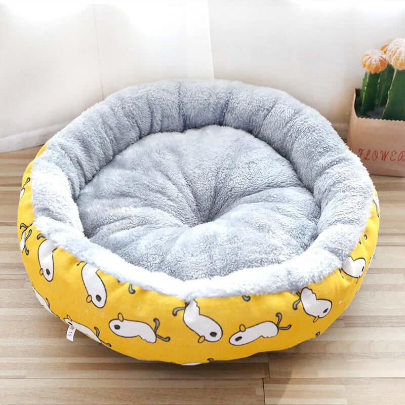 Padded pet litter bed made from Arctic fleece with cartoon patterns, perfect for dogs and cats, offering cozy comfort.