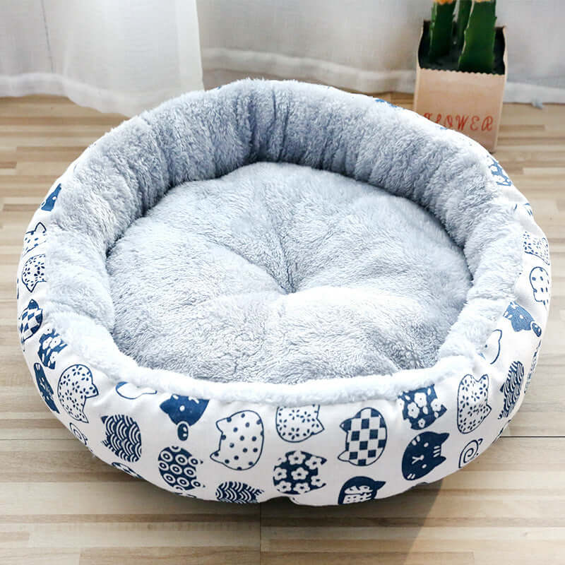 Padded pet litter bed made of soft fleece with cute cartoon patterns, perfect for dogs and cats in various sizes.
